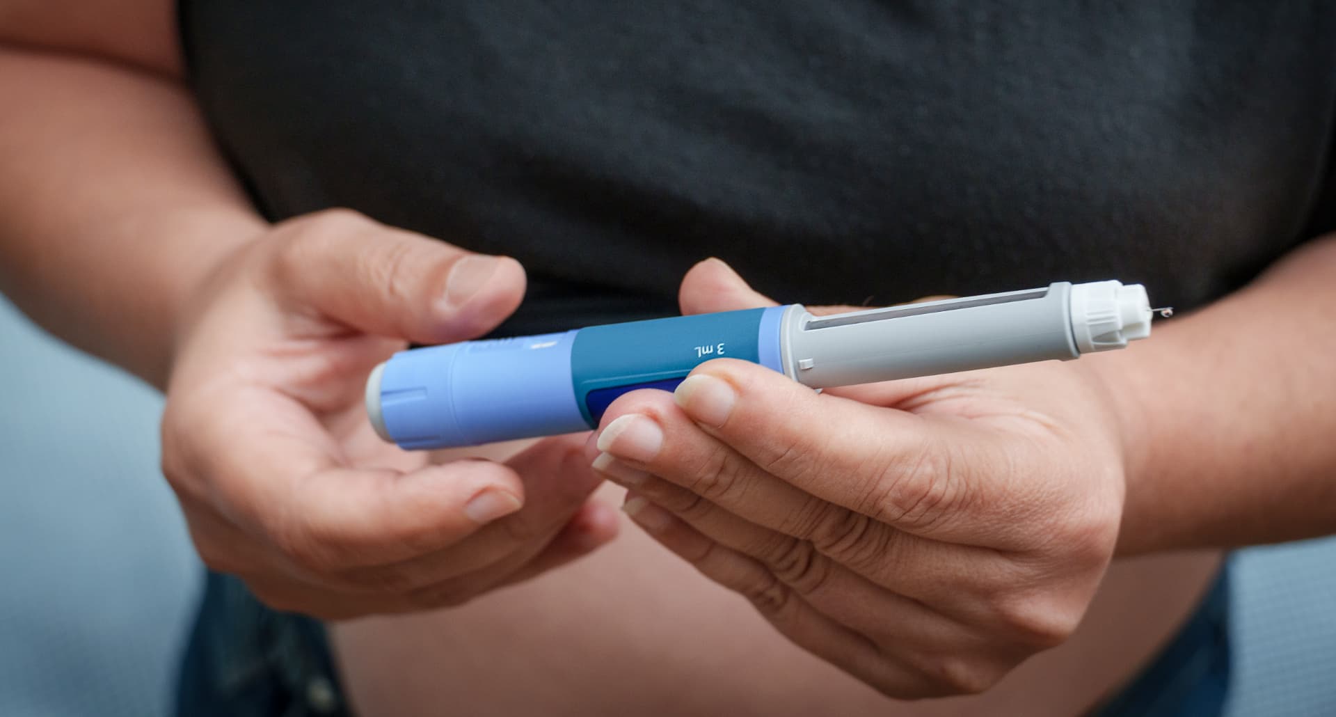 Woman using a GLP-1 injection pen
